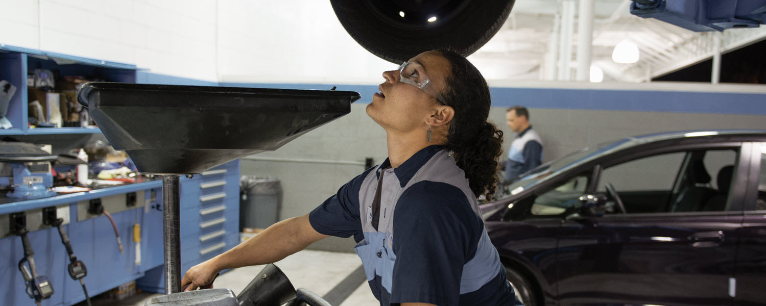 Mechanic in shop working under vehicle