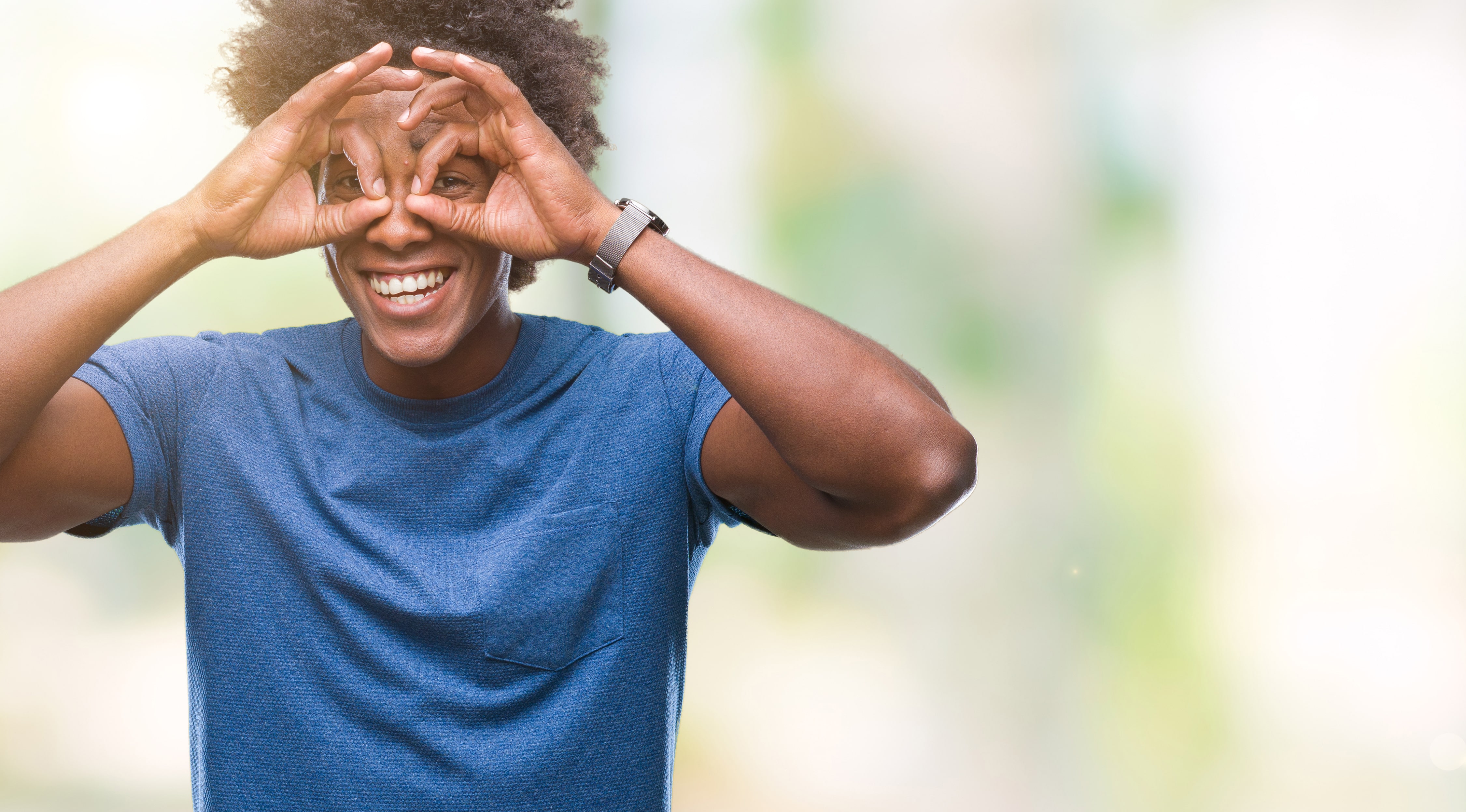 Man holding his hands up to his eyes like they're glasses